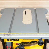 Gray zero clearance insert with center slot installed on a DeWalt 8-1/4" table saw, viewed from above