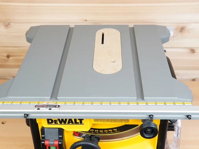 Gray zero clearance insert with center slot installed on a DeWalt 8-1/4" table saw, viewed from above