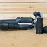 Black ToolCurve Dewalt quick-connect hose adapter fitted to a Festool tool's dust port, with two spare adapters alongside