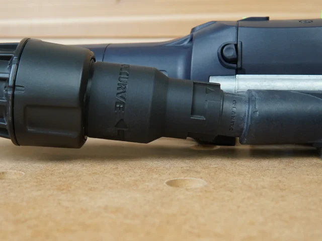 Black plastic Dewalt Quick Connect hose adapter with 27mm and 36mm ports, mounted on a Festool tool with hose attached