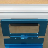Blue plastic holder mounted on MFT/3 table t-track with black guide rail square stored vertically inside