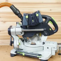 Dewalt Quick Connect hose adapter mounted on a Festool Kapex miter saw with orange hose attached