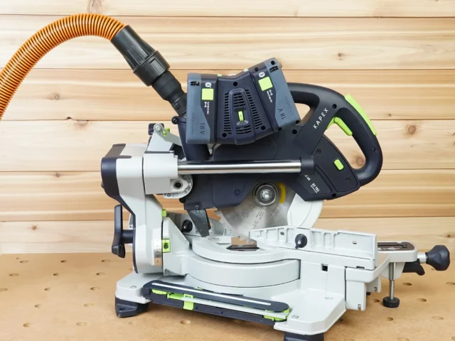 Dewalt Quick Connect hose adapter mounted on a Festool Kapex miter saw with orange hose attached