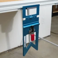 Blue TSO GRS-16 PE guide rail square hanging vertically from a holder in the side t-track of an MFT/3 table