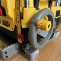 Yellow stubby handle with knurled knob installed on Dewalt DW735 planer height adjustment crank, replacing the standard long handle
