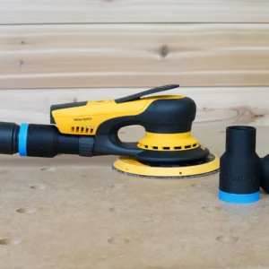 Black and blue ToolCurve hose adapters standing beside a Mirka Deros sander with hose connected, on a workbench