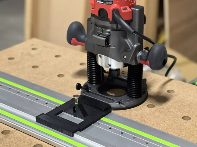 Black ToolCurve LR32 plate and rail adapter mounting a red Skil plunge router on an FS guide rail