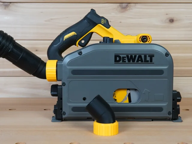 No Snag Dust Port Adapter attached to a DeWalt track saw, with black hose angled upward and yellow twist-lock connector visible