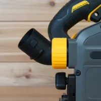 No Snag Dust Port adapter installed on a DeWalt track saw, showing the yellow hose connector angled upward and away from the saw base