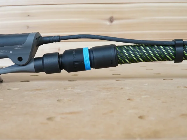 Hose adapter with blue band attached to 3M Xtract sander dust port, connected to green and black braided hose