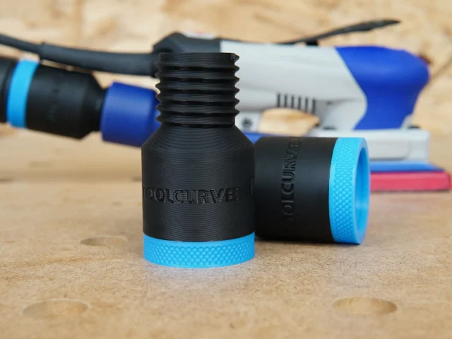 Black ToolCurve hose adapter with threaded port and blue grip ring, displayed with SurfPrep sanders in background