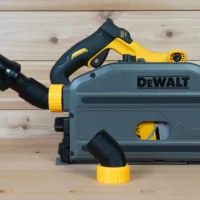No Snag Dust Port Adapter attached to a DeWalt track saw, with yellow and black hose fittings angled upward to direct dust extraction away from the cutting area