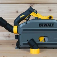 No Snag Dust Port adapter installed on a Dewalt track saw, with yellow and black hose adapter attached and vacuum hose routed upward