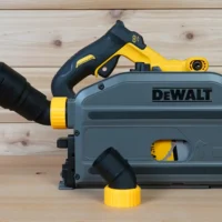 No Snag Dust Port Adapter installed on a DeWalt track saw, with yellow and black hose adapter angled upward from the dust port housing