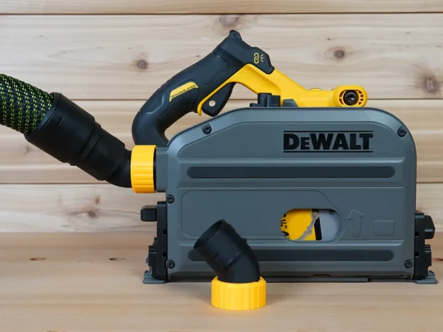 No Snag Dust Port Adapter installed on a DeWalt track saw, with yellow and black hose adapter angled upward from the dust port housing
