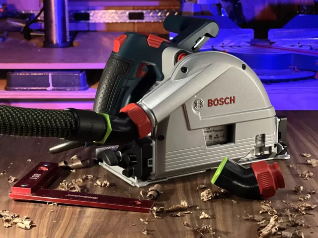 No Snag Dust Port adapter attached to a Bosch track saw, angling the hose upward away from the work surface
