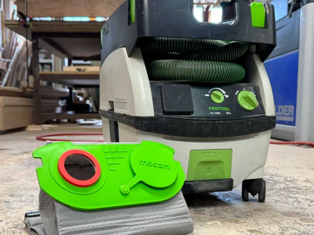 Bright green Macam reusable filter bag for Festool CT Mini/Midi dust extractor, displayed in front of the installed extractor unit