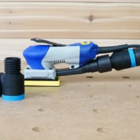 ToolCurve hose adapter for Ekasand sander with blue grip ring, shown with threaded port on left and connected to sander hose on right