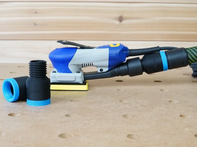 ToolCurve hose adapter for Ekasand sander with blue grip ring, shown with threaded port on left and connected to sander hose on right
