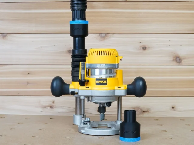 Black ToolCurve 1-7/8 inch hose adapter with blue band beside a DeWalt plunge router linked to a vac hose