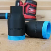 Two black hose adapters with blue grip rings, one showing the tapered end and the other the open connector end, marked with ToolCurve branding
