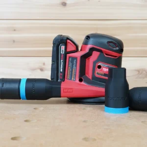 Black and blue ToolCurve hose adapter joining a vacuum hose to a Milwaukee M18 sander, with two spare adapters beside it