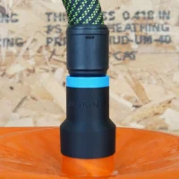 Black hose adapter with blue band installed on orange Dustopper cyclone separator
