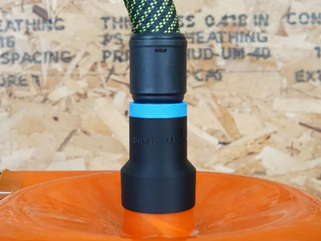 Black hose adapter with blue band installed on orange Dustopper cyclone separator
