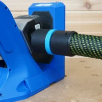 Black 36mm hose adapter with blue label ring joining a braided hose to a blue Kreg 720 pocket-hole jig