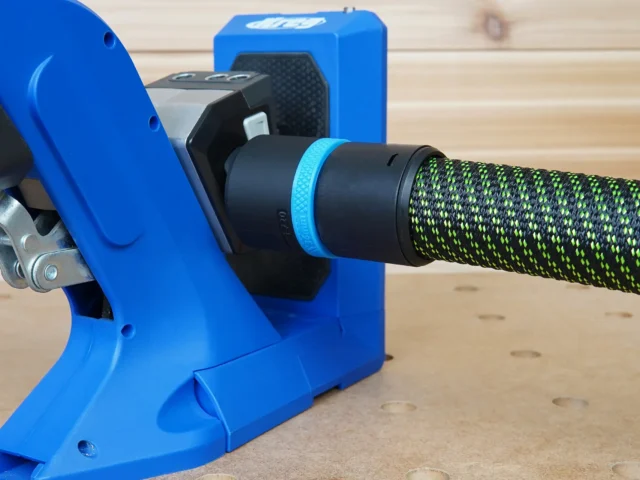 Black 36mm hose adapter with blue label ring joining a braided hose to a blue Kreg 720 pocket-hole jig