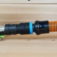 Black 1-1/4 inch hose adapter with blue band linking an orange hose to a 27mm Festool tool port