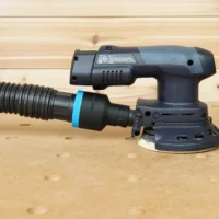 Black 1-7/8 inch hose adapter with blue ring joining a ribbed hose to the 27mm port of a Festool ETSC 125 sander