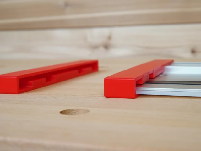 Red protective caps shown loose and installed on a Milwaukee aluminum guide rail