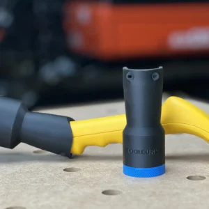 Black ToolCurve hose adapter with blue banded ends standing upright beside a yellow Proscrapper vacuum scraper