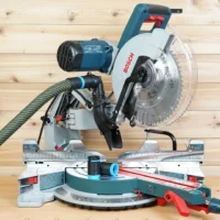 Black hose adapter with blue collar connecting a dust extractor hose to a Bosch 12-inch glide miter saw dust port
