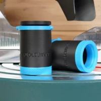 Two black hose adapters with blue grip bands, marked ToolCurve, shown standalone with measurement rulers in background