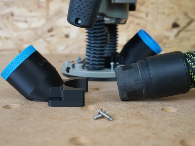 Black 36mm hose adapter with blue collar lying beside a Bosch 1617 plunge router base, dust hose cuff and two screws