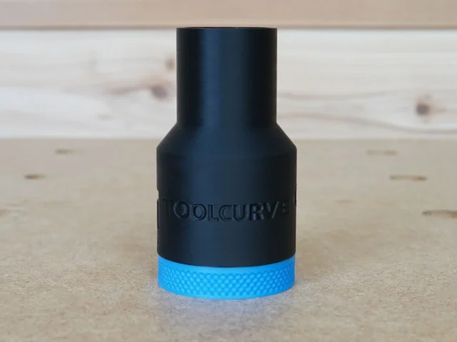 Black hose adapter with blue grip band and ToolCurve branding, shown at angle on wooden surface