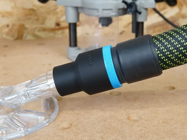 Black 36mm hose adapter with blue ring joining an extractor hose to a clear Oneida router hood port