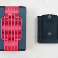 Black ToolCurve battery mount for Bosch 18v battery shown front and back views with two Phillips head screw holes visible