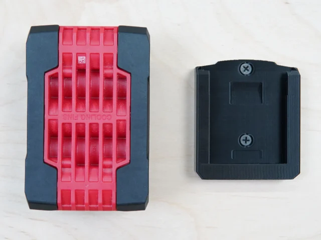 Black ToolCurve battery mount for Bosch 18v battery shown front and back views with two Phillips head screw holes visible