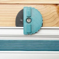 Turquoise wall mount clipped onto a silver Makita track rail, shown installed on wood and white surfaces