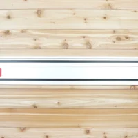 Milwaukee track saw guide rails mounted on wooden wall with red locking knobs and black mounting hardware