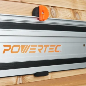 Wall mount with black bracket and orange knurled locking knob holding a Powertec guide rail on a wood wall
