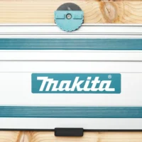 Light blue 3D-printed wall mount with locking mechanism attached to a Makita track saw guide rail