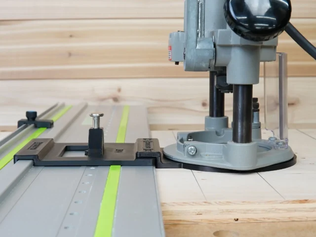 Porter Cable 690 router with LR 32 drilling jig mounted on Festool track, showing spring-loaded knob and guide rail stops positioned on plywood