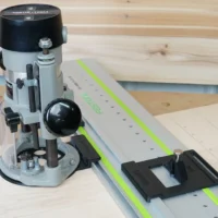 Porter Cable 690 router mounted on LR32 rail adapter with black plunge plate and drop stop, positioned on Festool guide rail