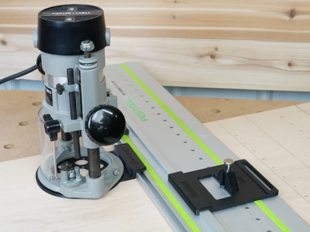 Porter Cable 690 router mounted on LR32 rail adapter with black plunge plate and drop stop, positioned on Festool guide rail