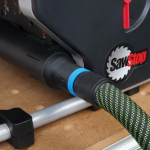 Black ToolCurve hose adapter with blue ring fitted to a SawStop Compact table saw rear dust port, hose attached