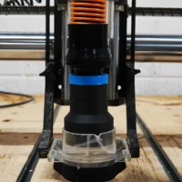 Black 1-1/4 inch hose adapter with blue collar installed on Onefinity CNC Suck It dust boot with brush skirt
